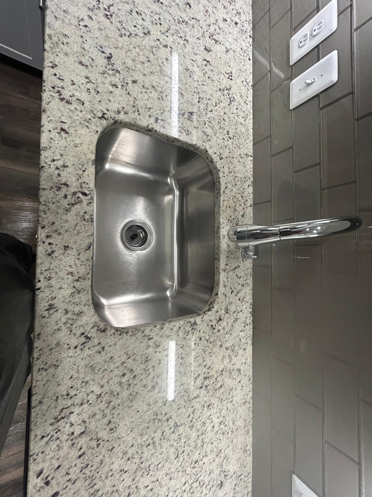 Polished granite countertop with stainless steel sink