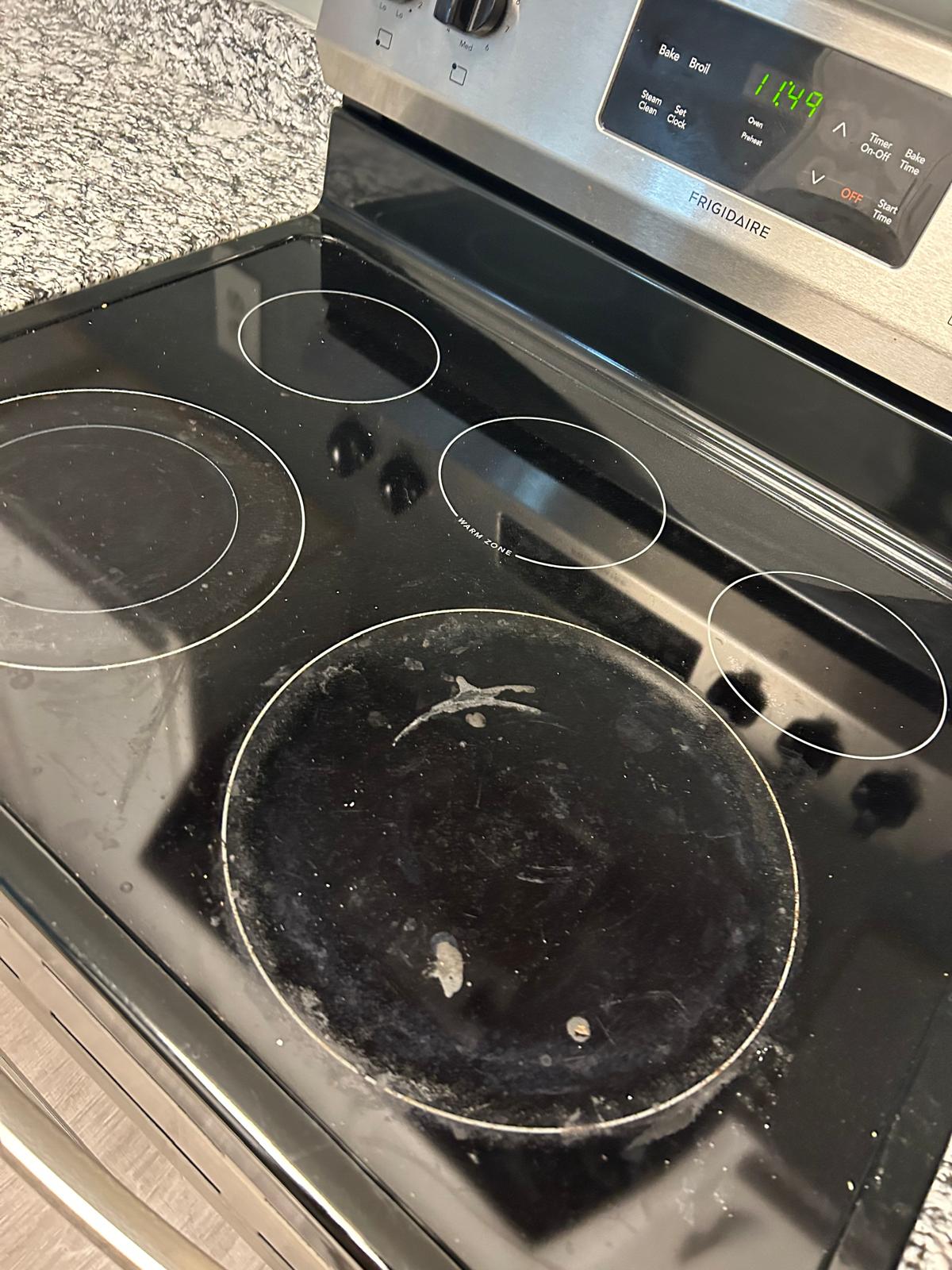 Dirty electric glass cooktop before deep cleaning